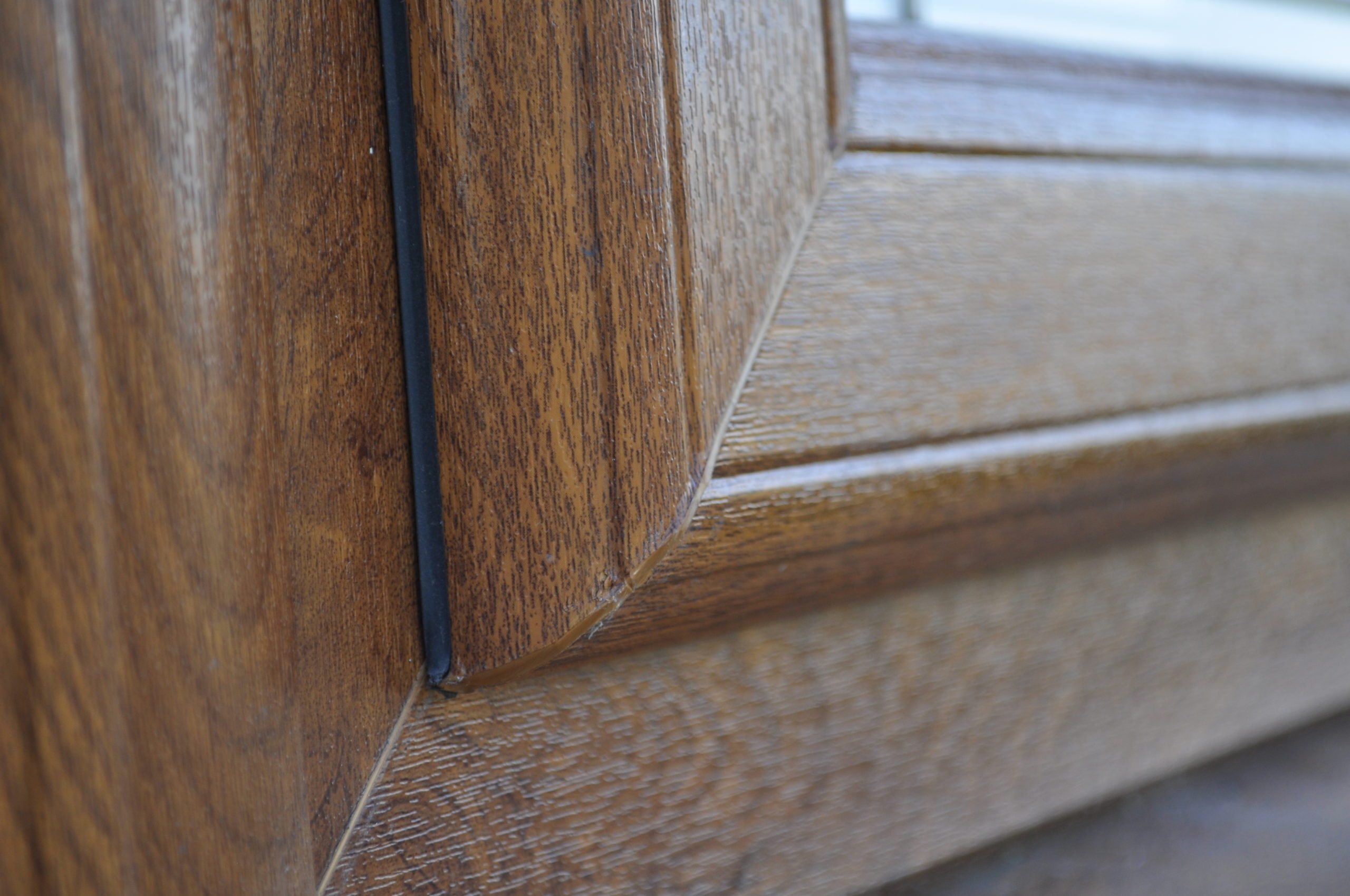 Close Up of Sculptured Casement UPVc Golden Oak Window